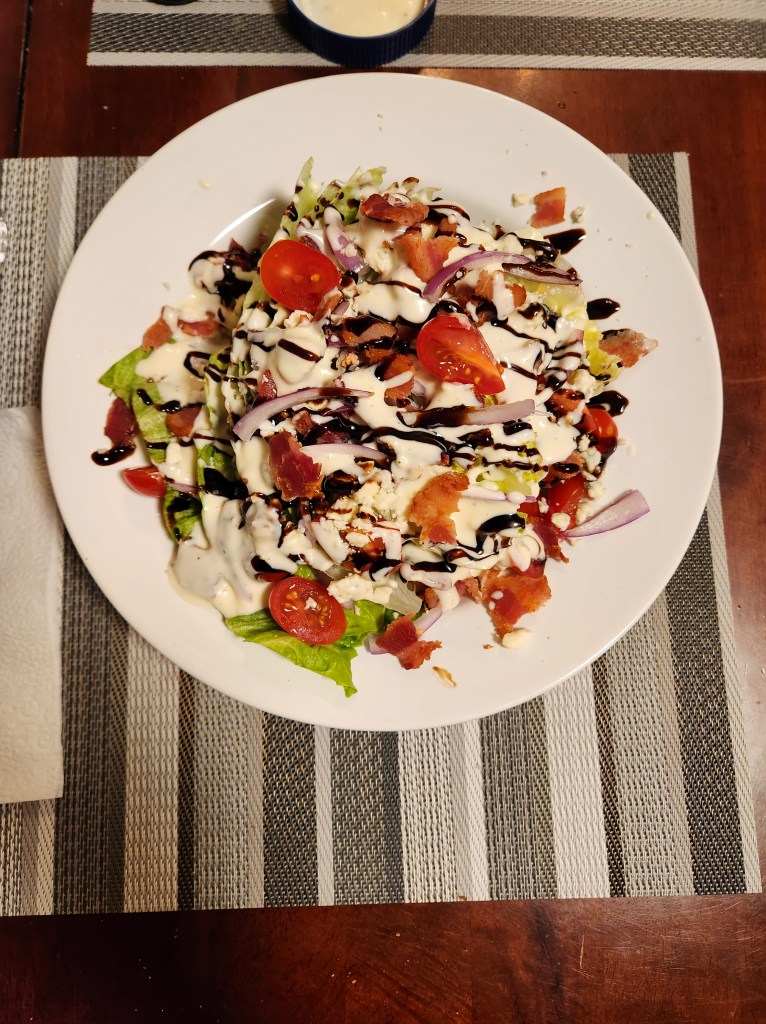 A delicious caprese and summer greens salad drizzled with balsamic reduction.