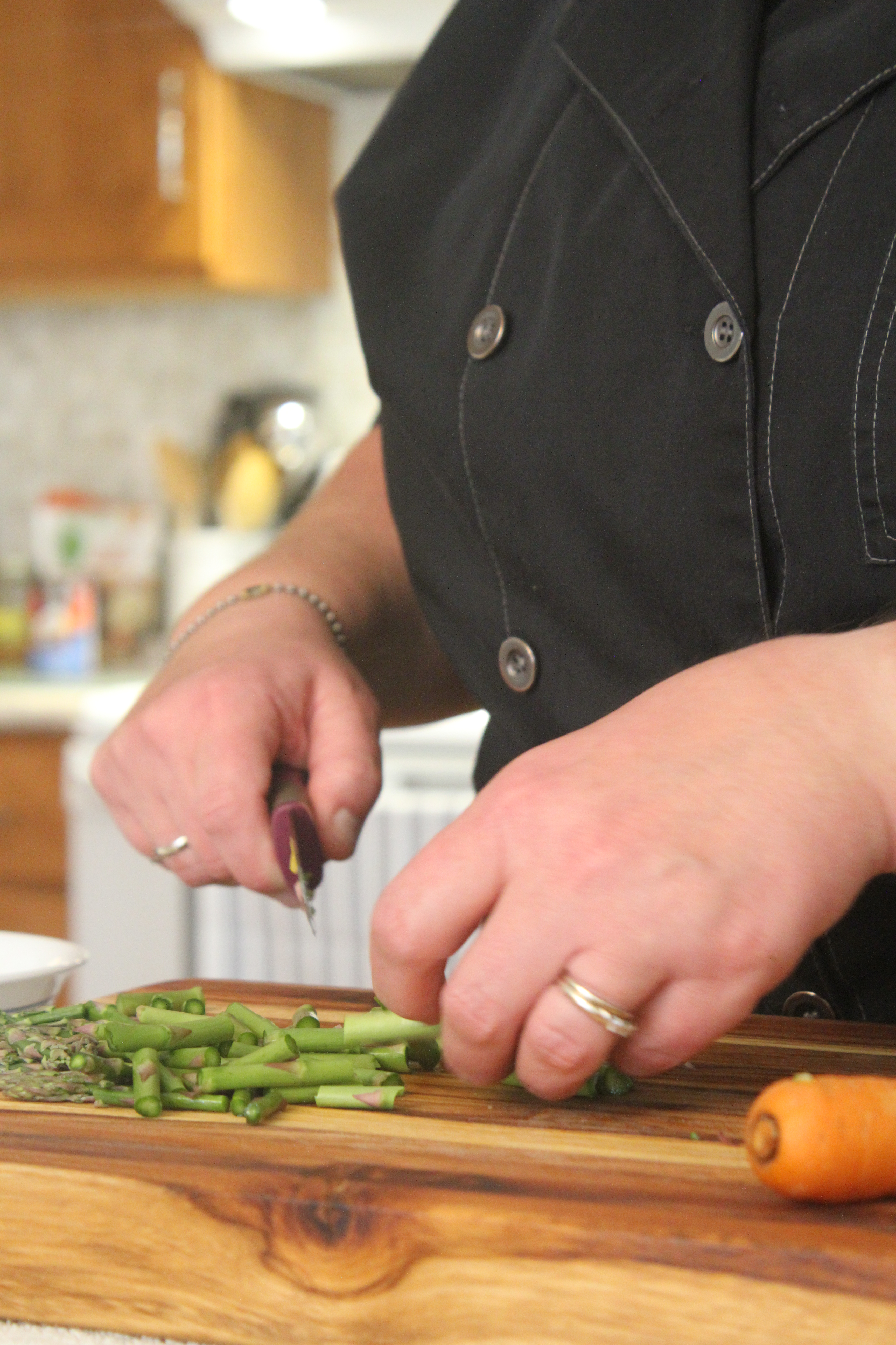 Chef jamie chopping up some celery on a cutting board.