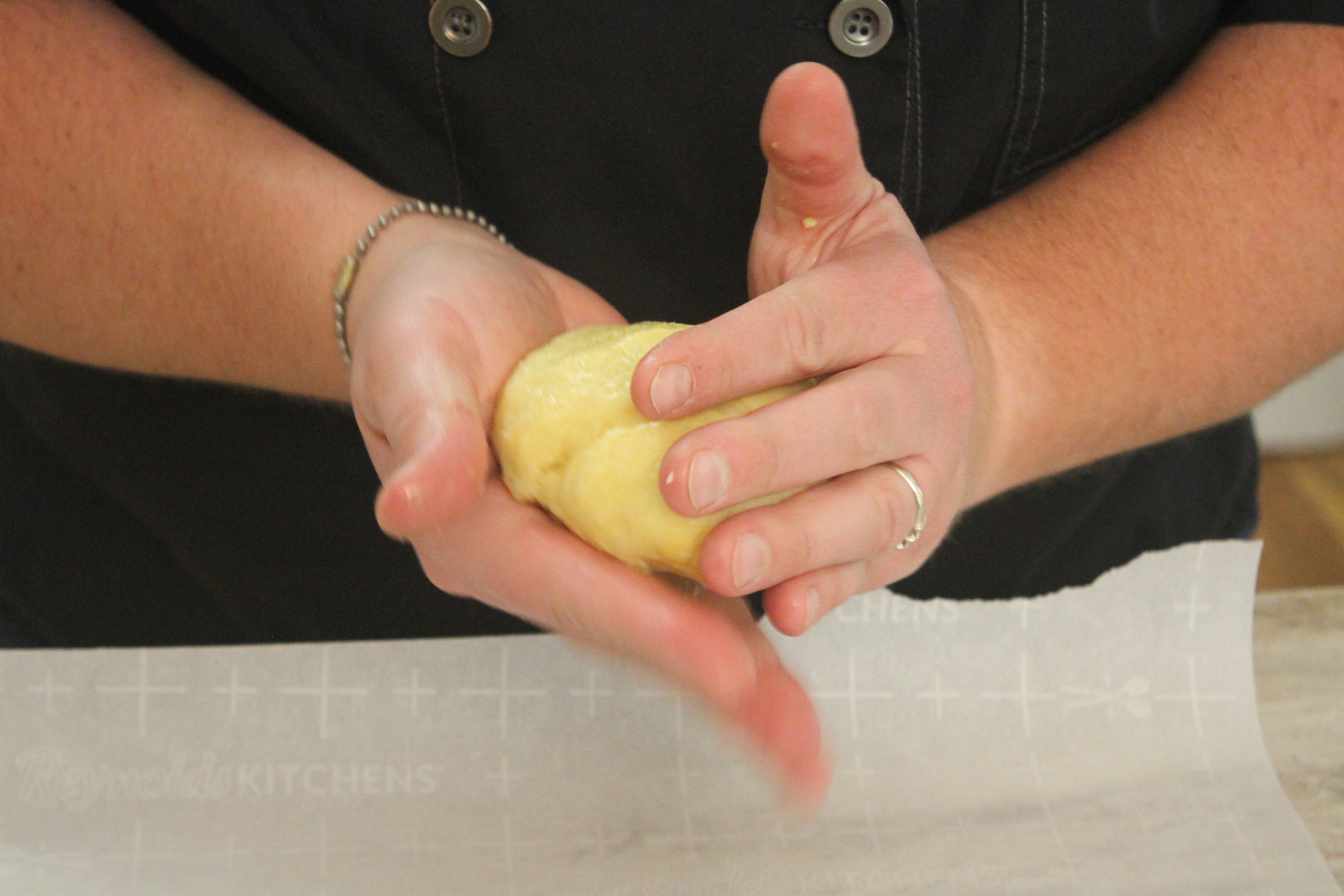 Chef Jamie's hands shaping the dough for her famous gluten free pizza crust.