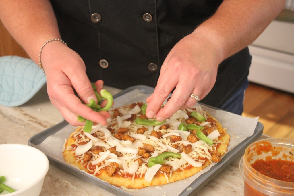 Chef Jamie's Almond Flour Crust pizza with sausage, cheese, onions, and green peppers.
